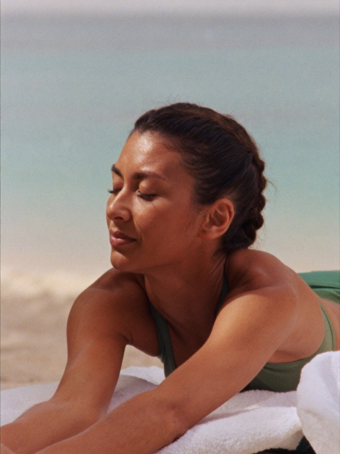 Woman stretching on a quiet morning beach