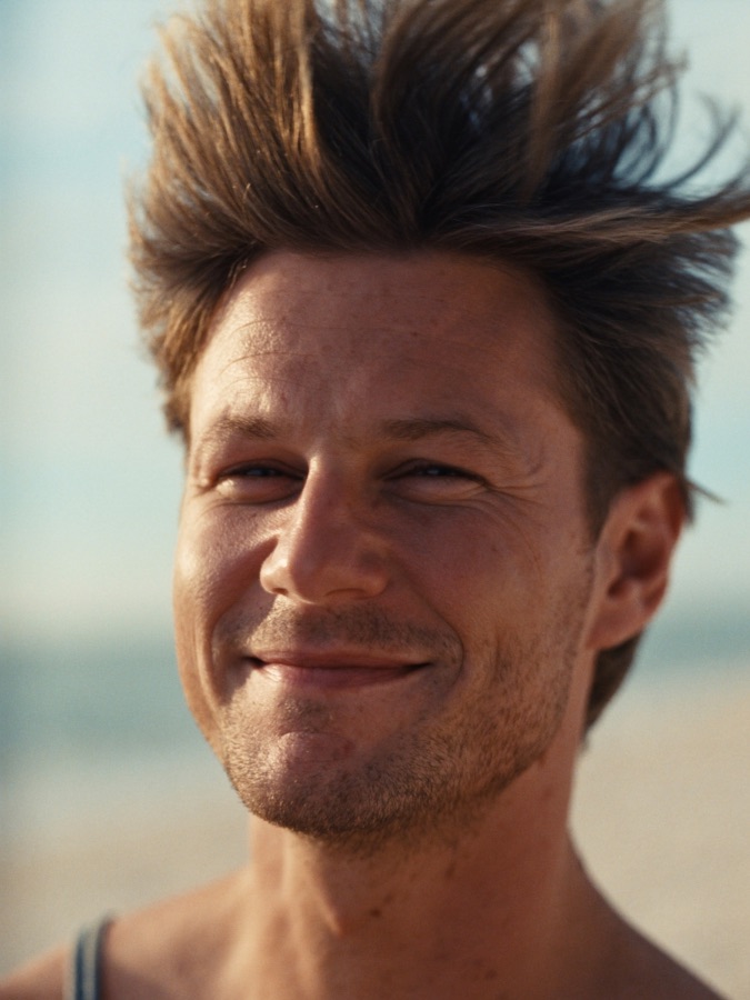 Man on a breezy beach with healthy hair